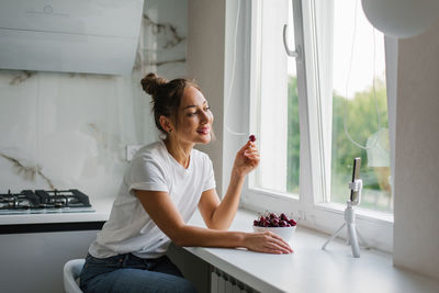 Young woman nutritionist blogger conducts a consultation or an open lesson by video link 