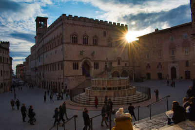 Group of people in front of historical building in city