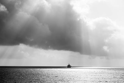 Ship on the open sea in rainy weather under the sun