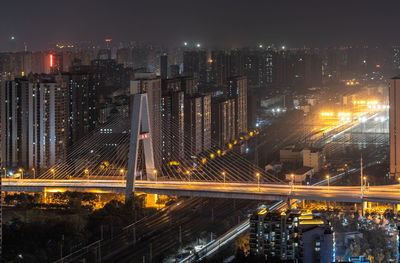 High angle view of illuminated buildings in city at night