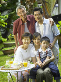 Portrait of happy family at back yard