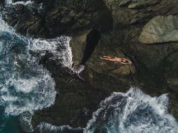 Full length of woman lying on rock