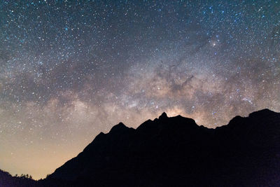 Scenic view of mountains against sky at night