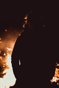 Portrait of silhouette man standing against sky at night