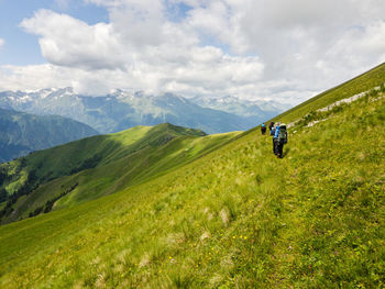 Rear view of person on mountain against sky