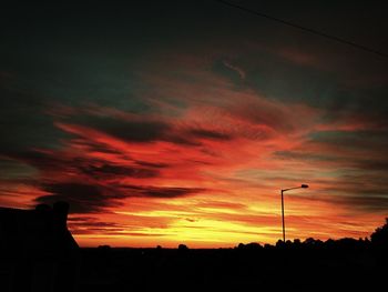 Low angle view of silhouette trees against sky at sunset