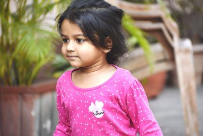 Portrait of cute girl standing outdoors