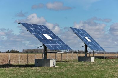 Solar panels outside a residential home and hobby farm on a sunny day. high quality photo