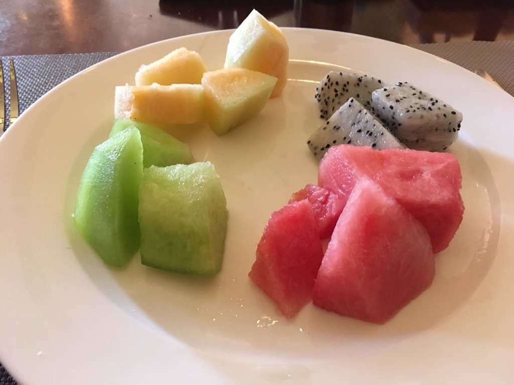 CLOSE-UP OF FRUIT SALAD IN PLATE WITH SAUCE