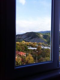 Trees on landscape seen through window