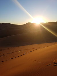 Scenic view of land against sky during sunset