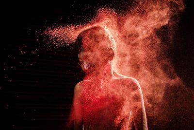High angle view of firework display at night