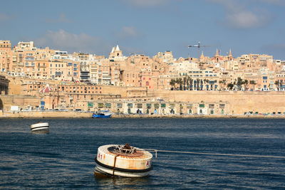 View of sea and buildings in city