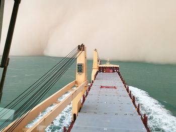 Low angle view of ship sailing on sea against sky