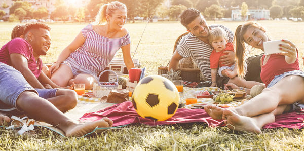 Group of people sitting on grassland