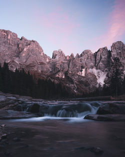 Scenic view of waterfall against sky