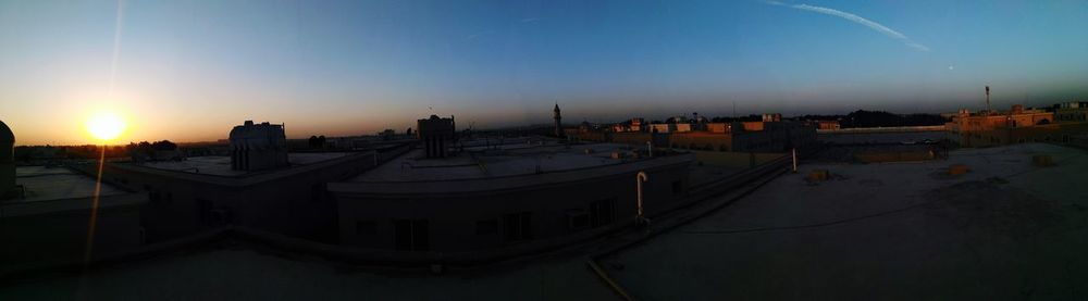 Panoramic view of cityscape against sky during sunset