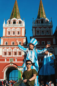 Portrait of people standing outside building