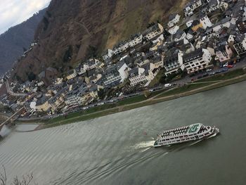 High angle view of barge on river by cityscape