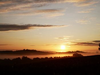 Scenic view of silhouette landscape against sky during sunset