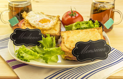 Cheese sandwich with black tea on table