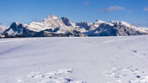 Scenic view of snow covered mountains against sky