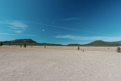 Scenic view of landscape against blue sky