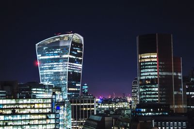 Low angle view of modern buildings at night