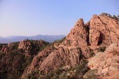 Rock formations on landscape against clear sky