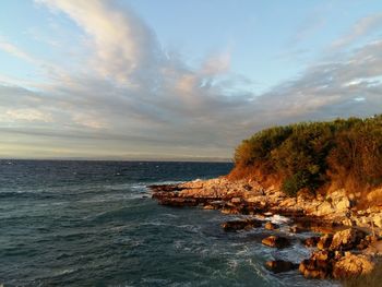 Scenic view of sea against cloudy sky