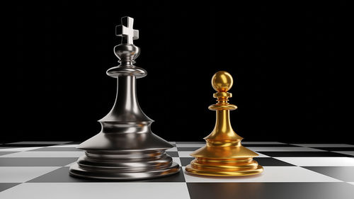 Close-up of chess pieces against black background