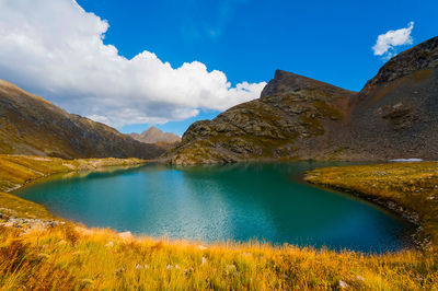 Scenic view of lake and mountains against sky