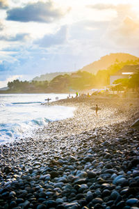 Scenic view of beach against sky during sunset