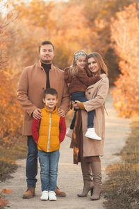 Portrait of father and son standing during autumn