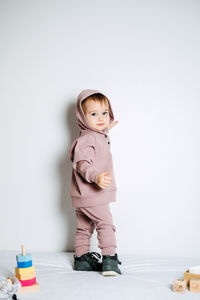 Unisex clothes for babies. cute baby in cotton set suit on light background. kids fashion