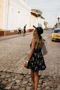 Woman walking on street in city