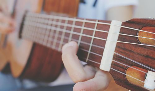 Cropped image of person playing guitar