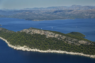 Scenic view of sea and mountains against sky