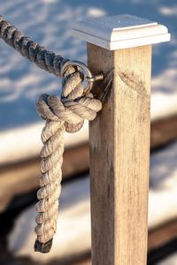 Close-up of rope tied on wooden post