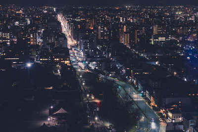 High angle view of illuminated city buildings at night