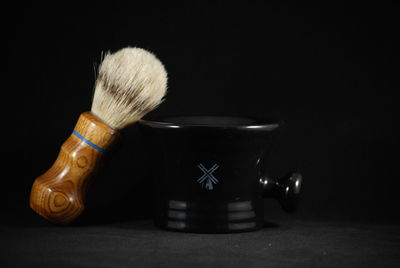 Close-up of toys on table against black background