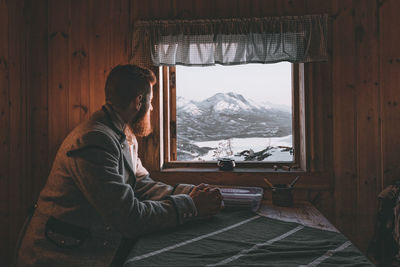 Side view of man in snow