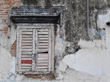 Closed window of abandoned house