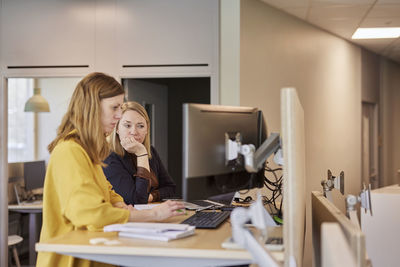 Women sitting at desk and using computer