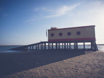 Built structure on beach against sky