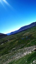 Scenic view of mountains against clear blue sky