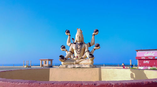 Low angle view of statue against clear blue sky