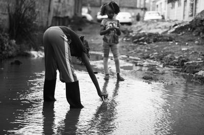 Girls playing in puddle