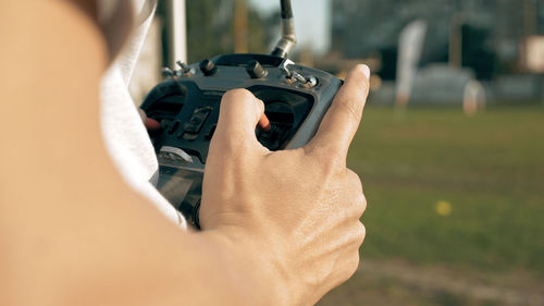 Cropped hand holding remote control