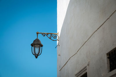 Low angle view of street light against building